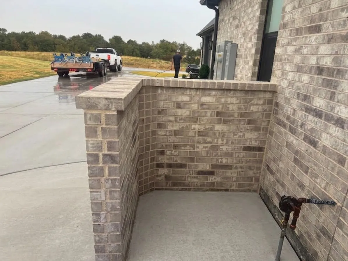 Brick screening wall built around residential trash cans in Fort Worth